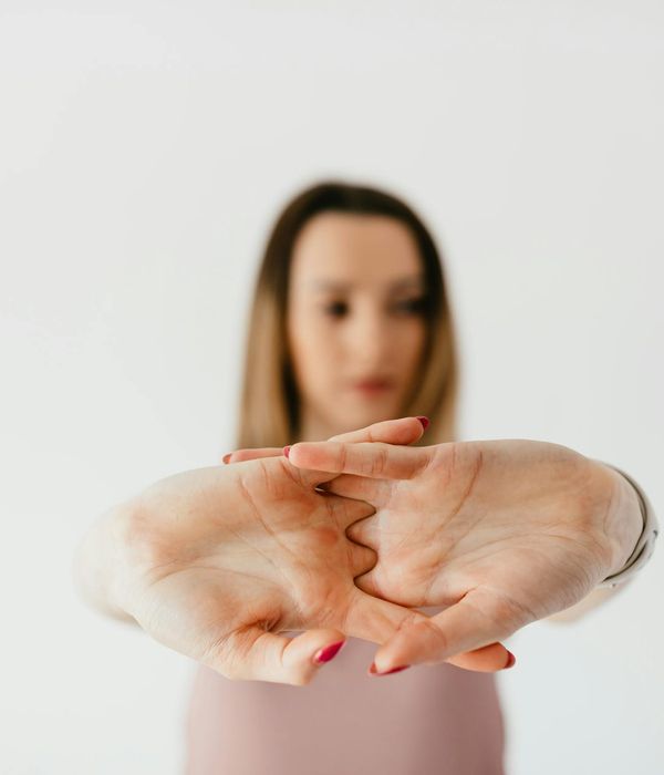 Woman practicing gentle balance movements in a dark studio